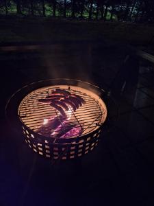 a large grill with a fire in it at Villa Irjala in Oulu