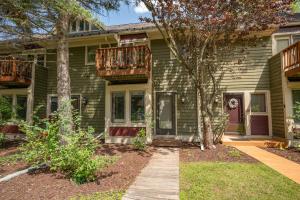 a green house with a walkway in front of it at Après 18 by Railey Vacations in McHenry