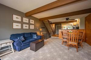 a living room with a blue couch and a table at Après 18 by Railey Vacations in McHenry