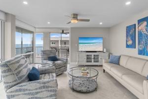 a living room with a couch and chairs and a television at Island Beach Club P4E in Sanibel