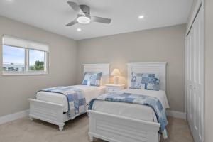 a bedroom with two beds and a ceiling fan at Island Beach Club P4E in Sanibel +46 photos