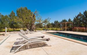 a group of lounge chairs next to a swimming pool at Es Triquet in Binissalem