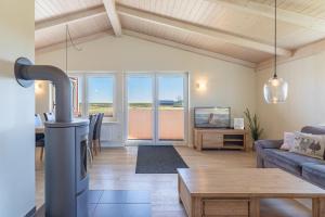 a living room with a couch and a table at Ferienhaus Strandflieder in Dagebüll
