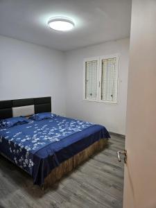 a bedroom with a bed with blue sheets and a window at Riverfront Villa 069 in Terre Rouge +17 photos