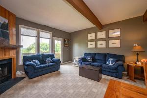 a living room with two blue couches and a fireplace at Après 18 by Railey Vacations in McHenry