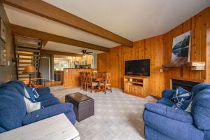 a living room with two blue couches and a television at Après 18 by Railey Vacations in McHenry +32 photos
