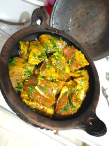 a pan filled with food on top of a stove at CASA Marwane in Chefchaouen +11 photos
