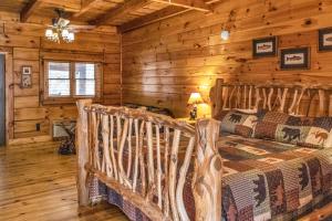 a bedroom with a bed in a log cabin at Riverfront Lodge in Tellico Plains