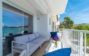 a balcony with a couch and a view of the ocean at Voramar On Pinewalk in Pollença