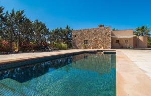 a swimming pool in front of a house at Es Triquet in Binissalem