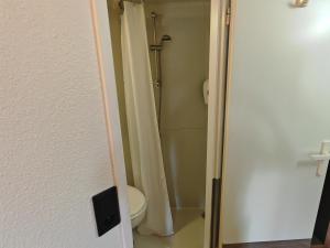 a bathroom with a toilet and a shower curtain at Premiere Classe Dunkerque Est Armbouts Cappel in Armbouts-Cappel +32 photos
