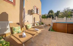 a patio with chairs and a ping pong table at Casa Hermosa in Capdepera