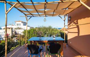 a patio with a blue table and chairs at Estrella De Son Serra in Son Serra de Marina +34 photos