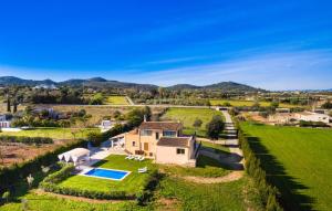 an aerial view of a house in a field with a pool at Finca Llum in Manacor