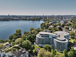 an aerial view of a building next to a river at The Fontenay Hamburg in Hamburg