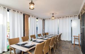 a dining room with a long table and chairs at Finca Sa Pedrera in Can Picafort +39 photos