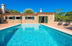 a villa with a swimming pool and a house at Can Baldo in Sencelles