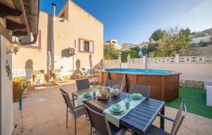 a patio with a table and chairs and a pool at Casa Hermosa in Capdepera