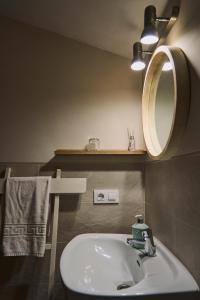 a bathroom with a sink and a mirror at Casilla Soleá Rural in Carcabuey +8 photos