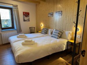 a bedroom with two beds with towels on them at Cal Not Celler, Cerdanya in Escardacs