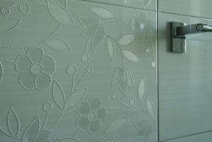 a shower door with a pattern on the wall at La Casa di Boz B&B in Nuoro