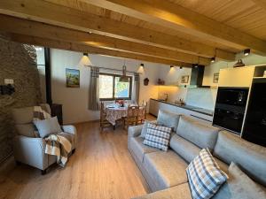 a living room with a couch and a kitchen at Cal Not Celler, Cerdanya in Escardacs +19 photos