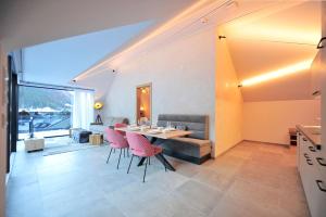 a dining room and living room with a table and chairs at Appartement Chesa Monte in Ischgl