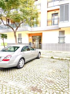 a car parked in front of a building at Zenit little house or basic room in Olhão