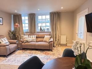 a living room with a couch and a table at Creel Cottage, Lower Largo in Lower Largo