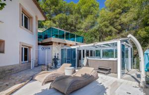 a patio with chairs and a glass house at Ocean View in Palma de Mallorca