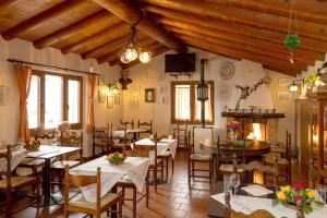 a restaurant with tables and chairs and a fireplace at BnB "A la Crus" in Crana