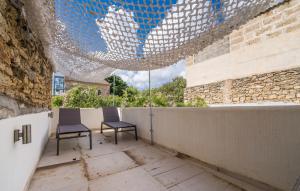 two chairs sitting on a patio with a ceiling at Ca Sa Batlessa in Artá