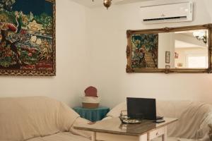 a living room with a couch and a mirror at Casilla Soleá Rural in Carcabuey