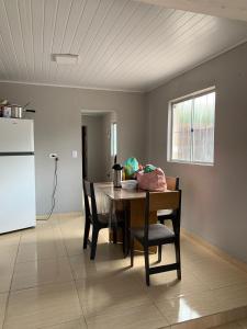 a kitchen with a table and chairs and a refrigerator at Edilson santos in João Pessoa