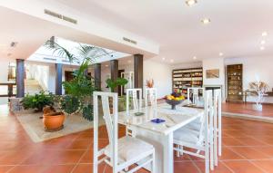 a dining room with a white table and chairs at Turixant Dalt in El Port de la Selva +36 photos