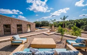 a patio with couches and a table and chairs at La Fuente De Montuiri in Montuiri +39 photos