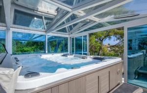 a large tub in a room with windows at Ocean View in Palma de Mallorca