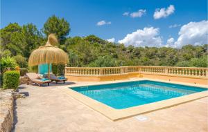 a swimming pool in a backyard with a umbrella at Es Socorrat in Portocolom