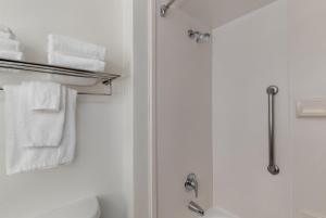 a bathroom with a shower and white towels at Garner Hotel Murfreesboro West by IHG in Murfreesboro