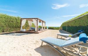 a couple of lounge chairs on the beach at Sa Platja in Playa de Muro