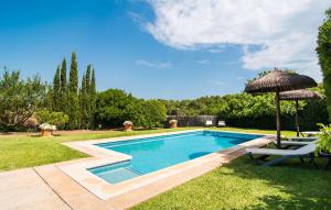 a swimming pool with an umbrella and a table and chairs at Can Polito in Can Picafort