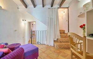 a living room with a purple couch and stairs at Maria Angela in Artá +14 photos