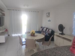a kitchen and living room with a table and a couch at Paradise in Estância