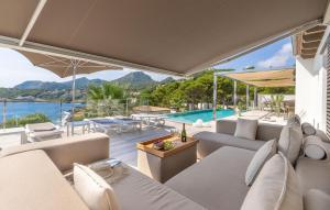 an outdoor living room with a view of the water at Lifetime in Font de Sa Cala
