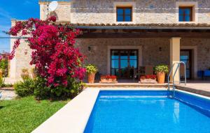 a villa with a swimming pool in front of a house at Etv4268, Casa Tolo in Son Servera