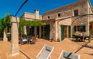 an outdoor patio with a table and chairs at Villa Maria De Betlem in Colonia de Sant Pere