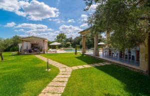 a garden with a pathway leading to a house at Golf Marina in Pollença +44 photos