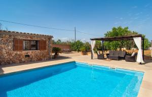a villa with a swimming pool and a gazebo at S'hortet in Campos