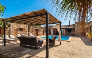 acovered patio with chairs and a swimming pool at S'hortet in Campos