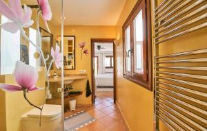 a hallway with pink flowers on the wall at Maria Angela in Artá
